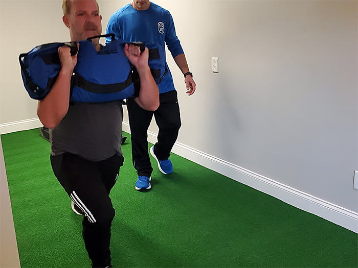 Scott Doing the Walking Lunge With a Sandbag